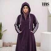 A woman is wearing a modest, sporty-style long outer garment in a deep color.